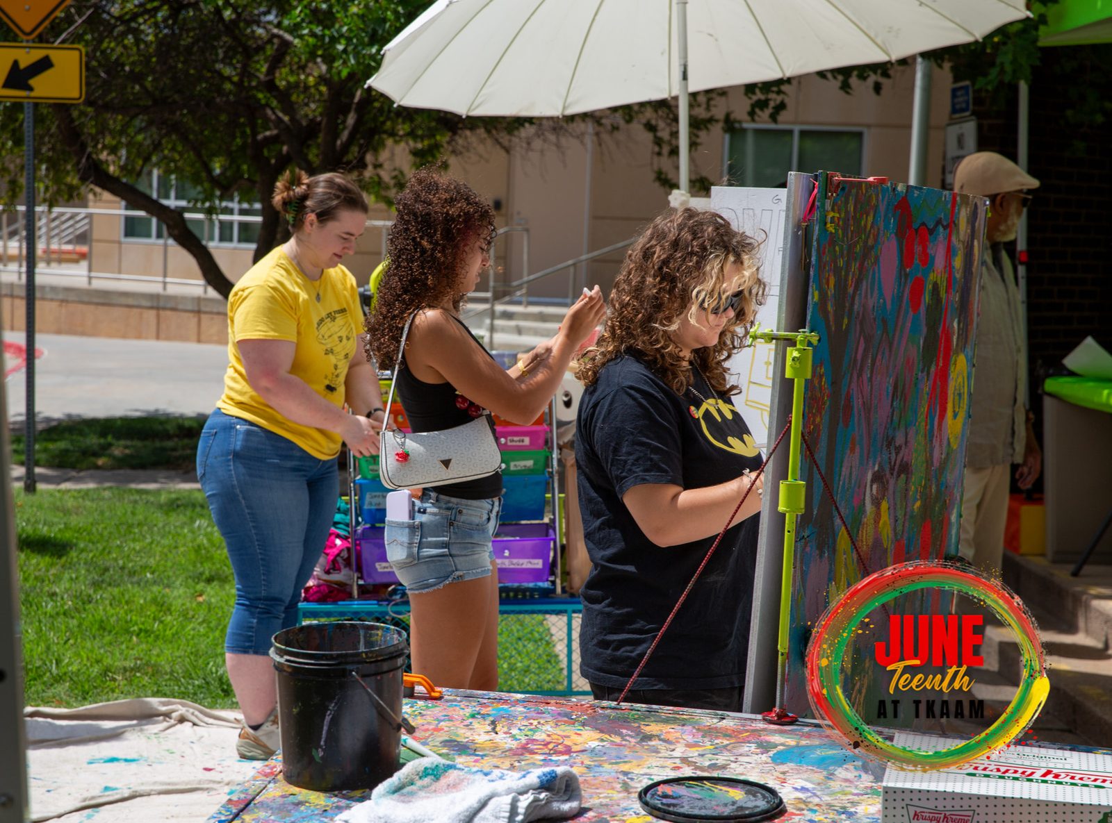 Guests painting the community mural at Juneteenth 2026 at TKAAM